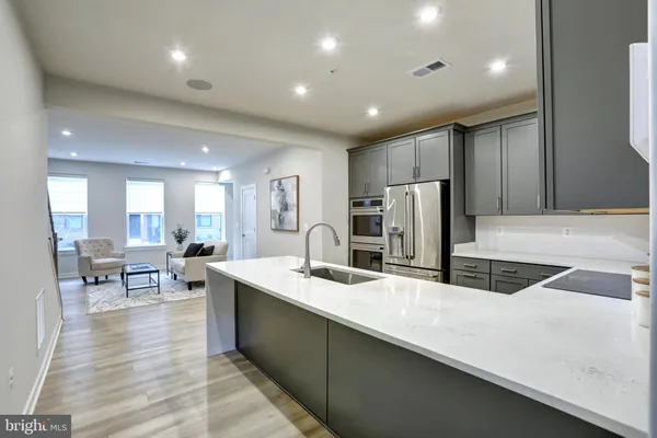 a kitchen with center island a sink stainless steel appliances and cabinets