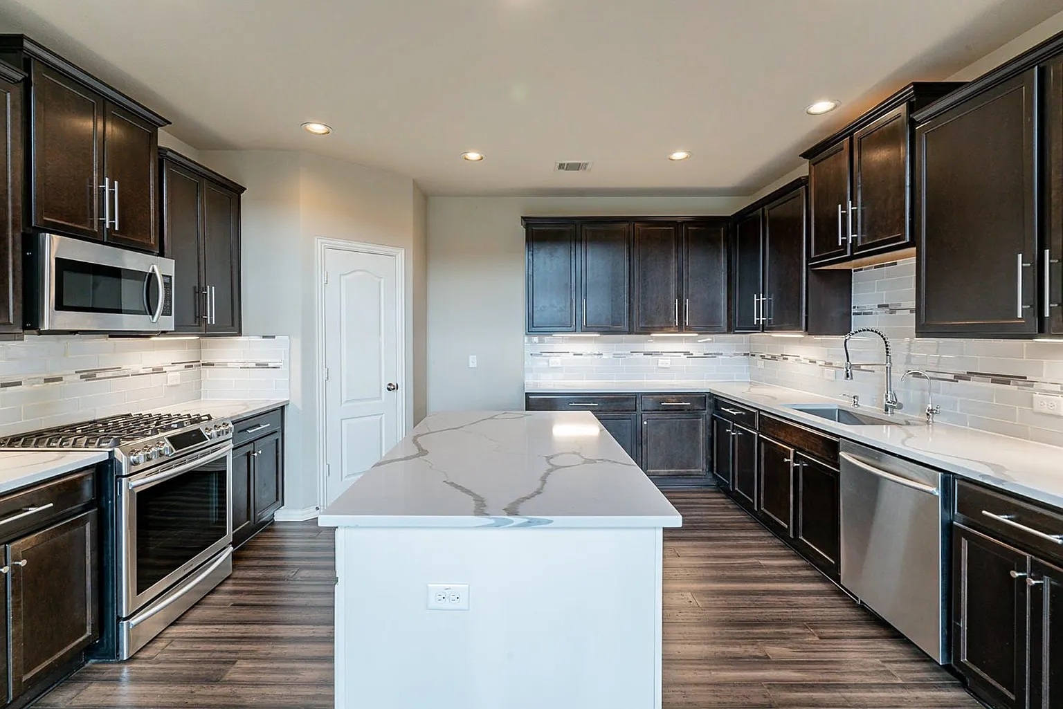 19717 Abigail Way Pflugerville, TX 78660 - Photo 5 of 9 a kitchen with a stove sink and microwave