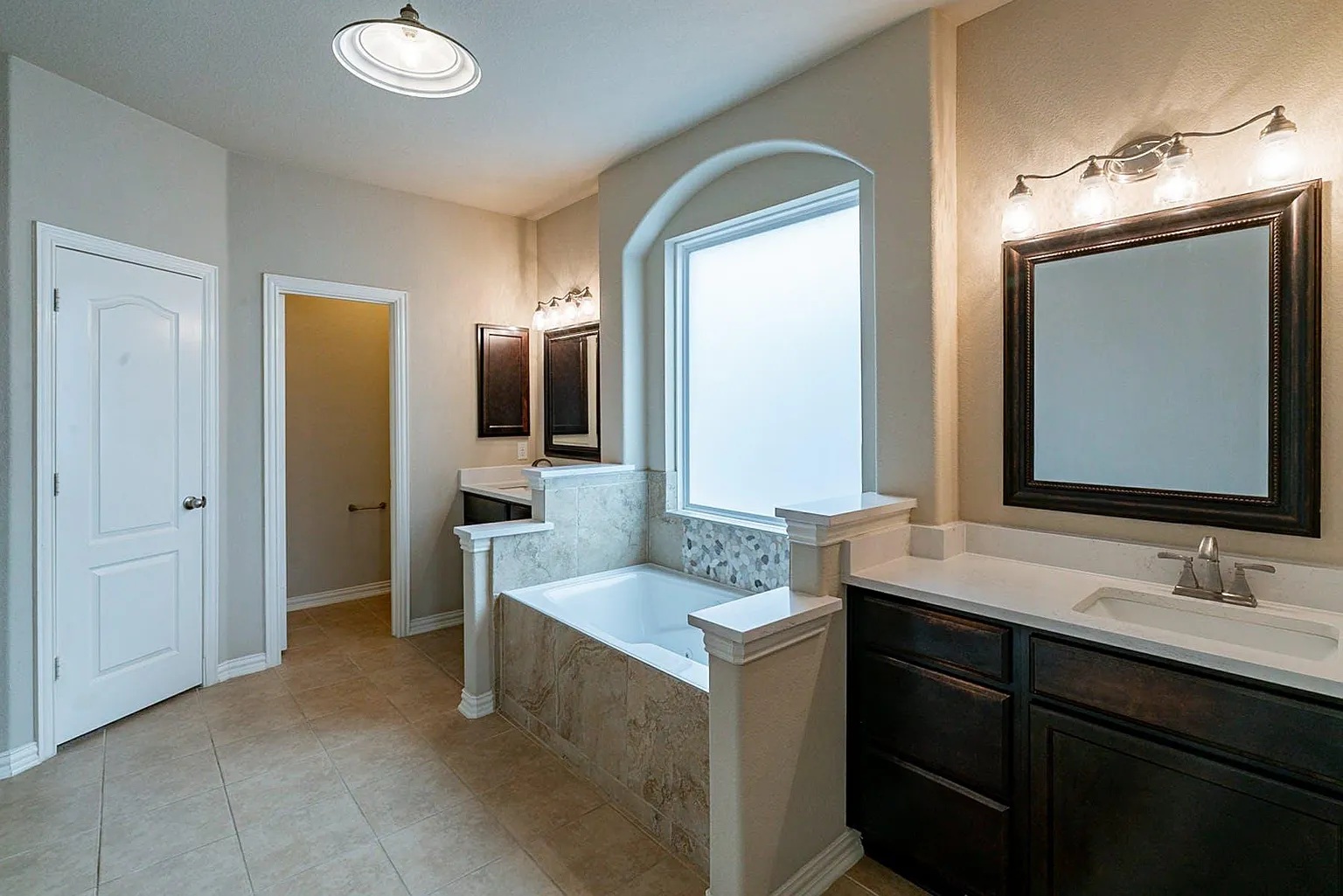 19717 Abigail Way Pflugerville, TX 78660 - Photo 7 of 9 a bathroom with a double vanity sink and a mirror