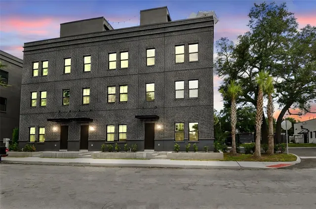 a view of a brick building next to a road