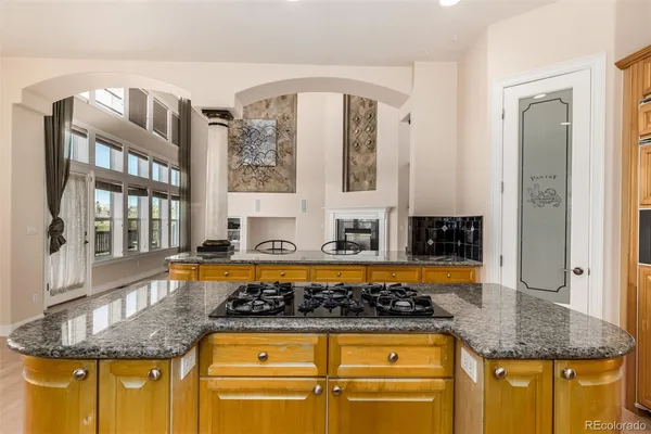 a kitchen with stainless steel appliances granite countertop a stove and a dining table