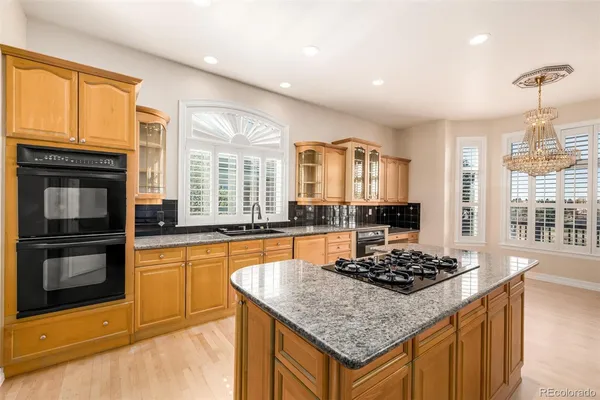 a kitchen with a stove a sink and a refrigerator