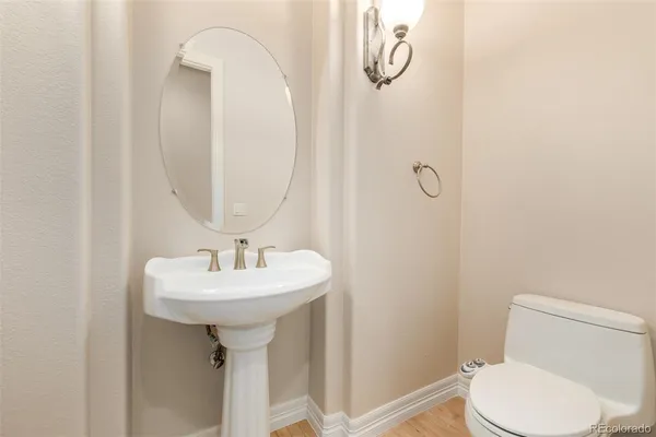 a bathroom with a sink a toilet and mirror
