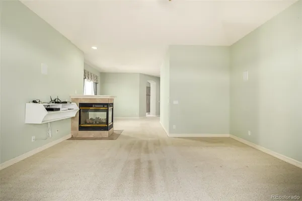 a view of an empty room with a fireplace
