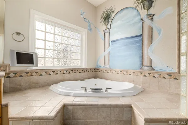 a bathroom with bathtub and window