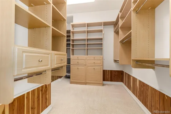 a view of walk in closet and bedroom