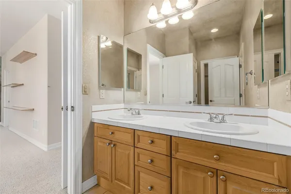 a bathroom with a double vanity sink and a mirror
