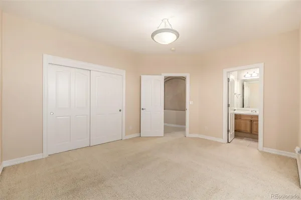 a view of an empty room and a bathroom