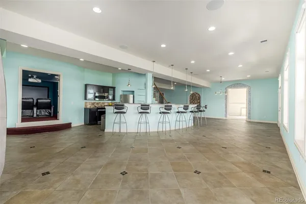 a view of kitchen with furniture and refrigerator