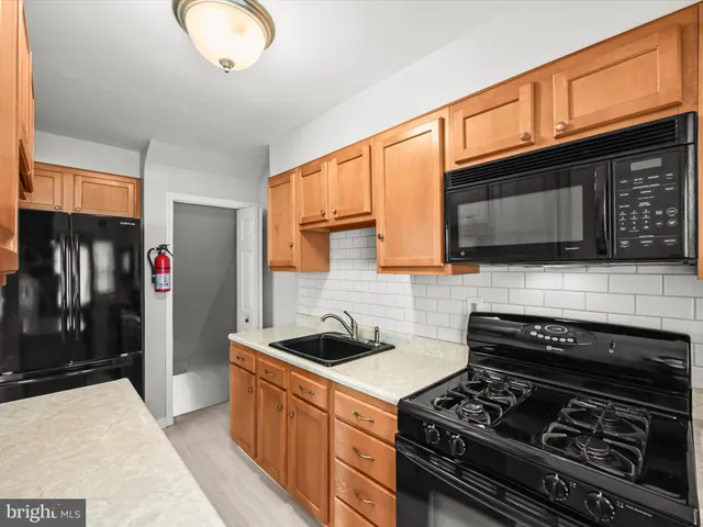 a kitchen with stainless steel appliances granite countertop a stove and a microwave