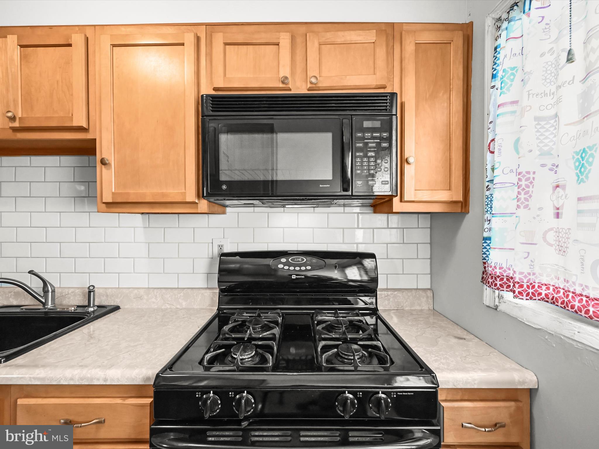 1913 Nevill Road Baltimore, MD 21222 - Photo 13 of 37 a kitchen with granite countertop a stove and a sink