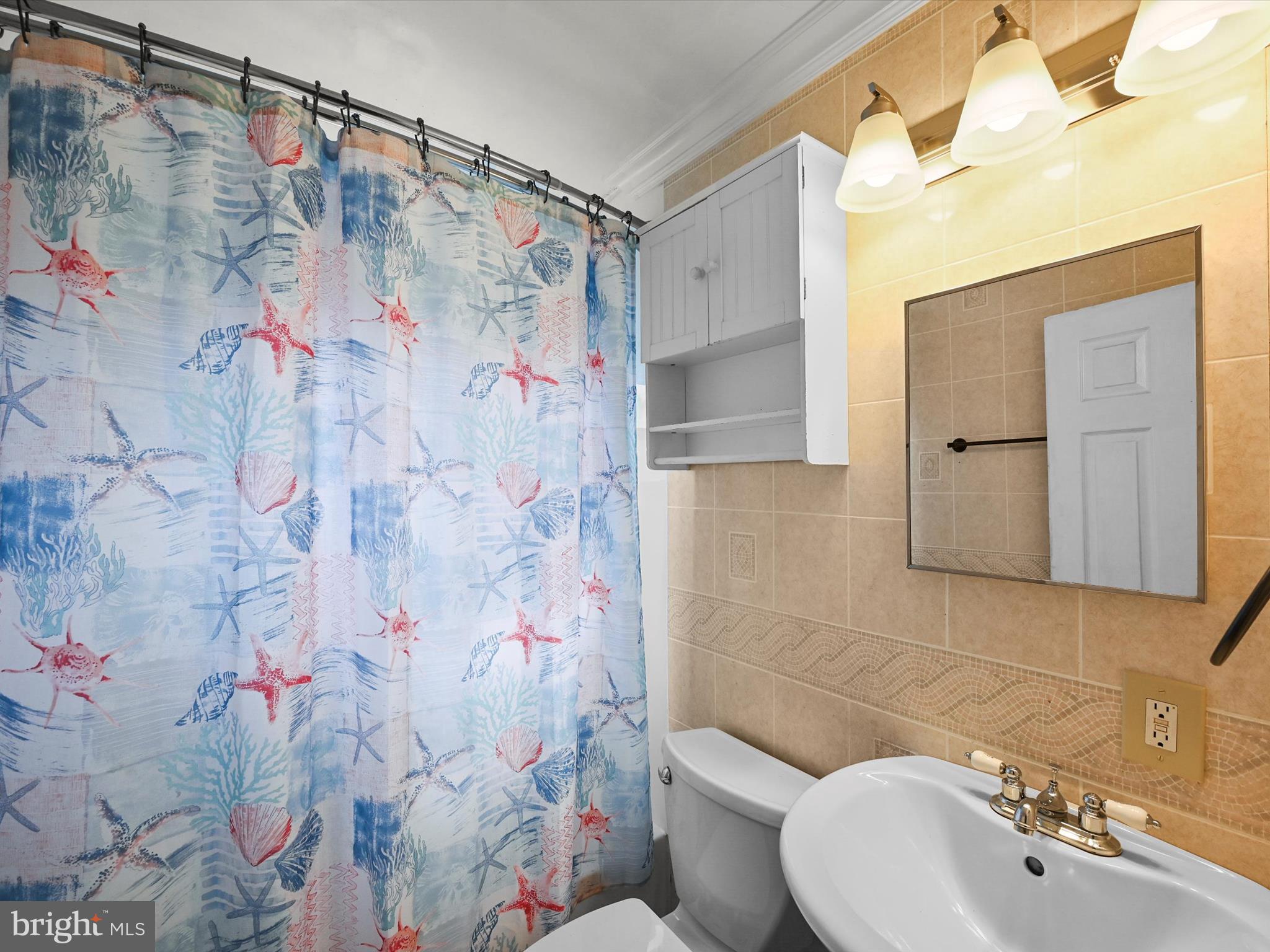 1913 Nevill Road Baltimore, MD 21222 - Photo 19 of 37 a bathroom with a sink and mirror with toilet