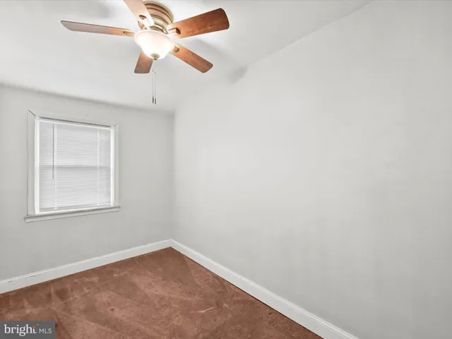 a view of a hallway with a chandelier fan