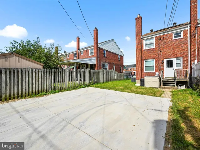 a view of staircase with wooden floor and white walls