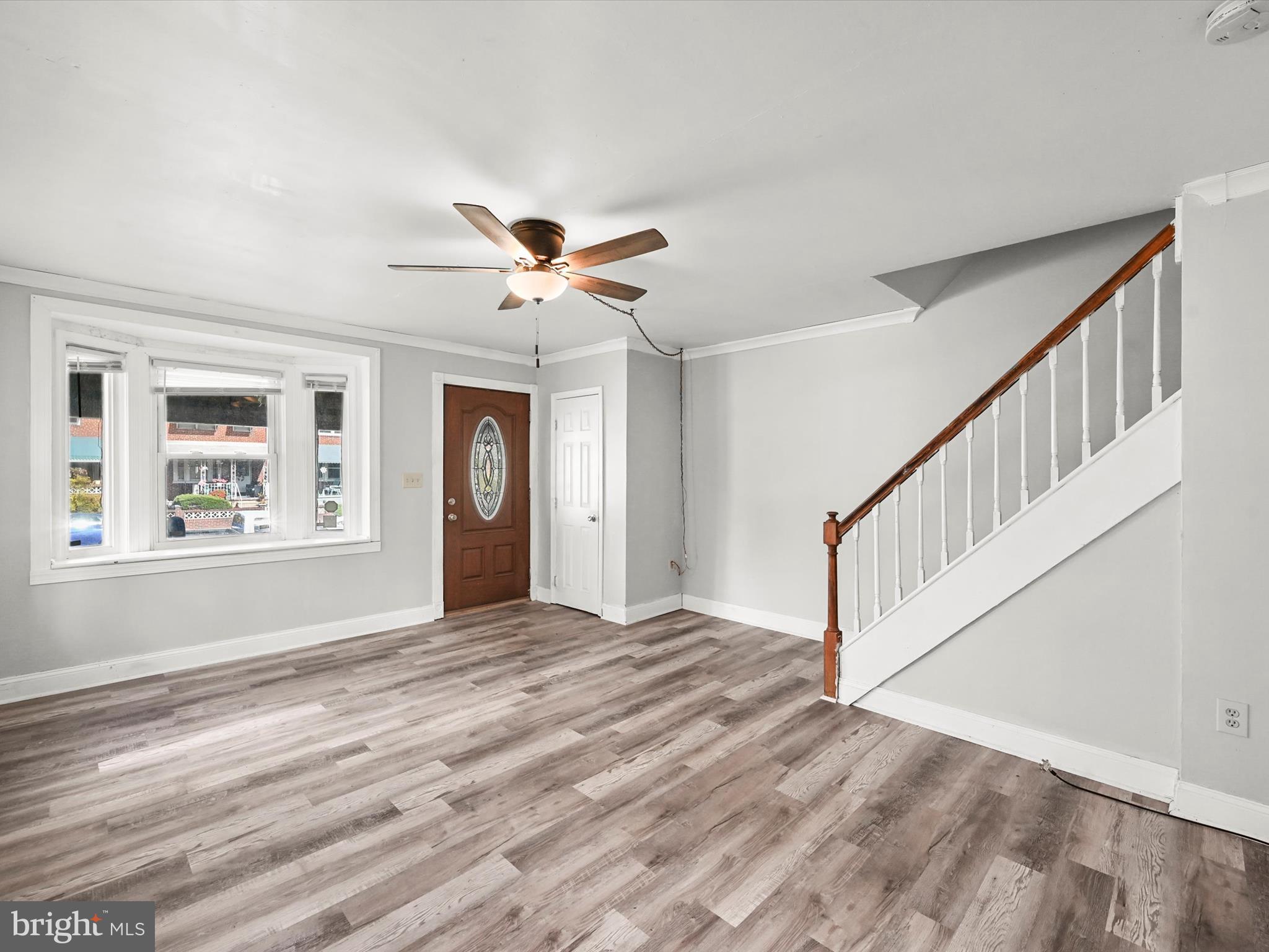 1913 Nevill Road Baltimore, MD 21222 - Photo 5 of 37 a view of an empty room with a window and a chandelier