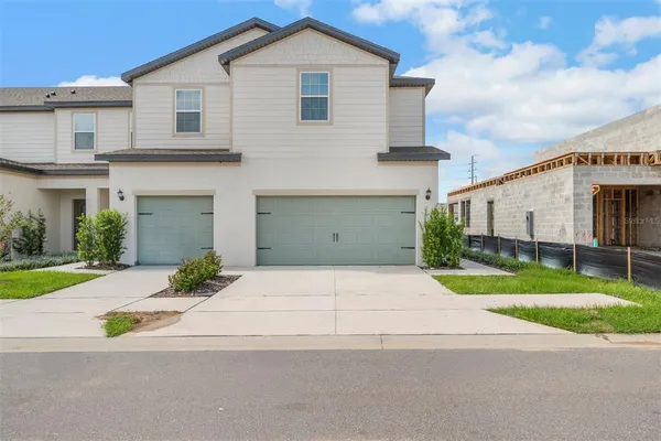 a front view of a house with a yard and garage
