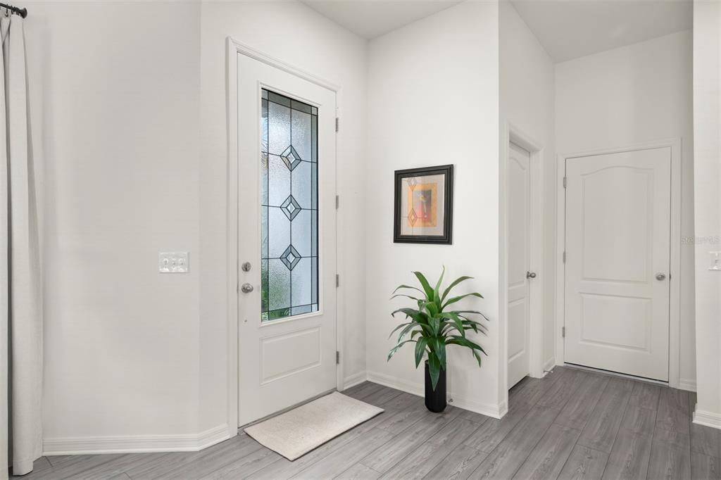 727 Poppy Lane Dundee, FL 33838 - Photo 12 of 31 an empty room with wooden floor and a hallway