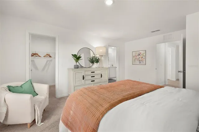 a bedroom with a bed and a couch