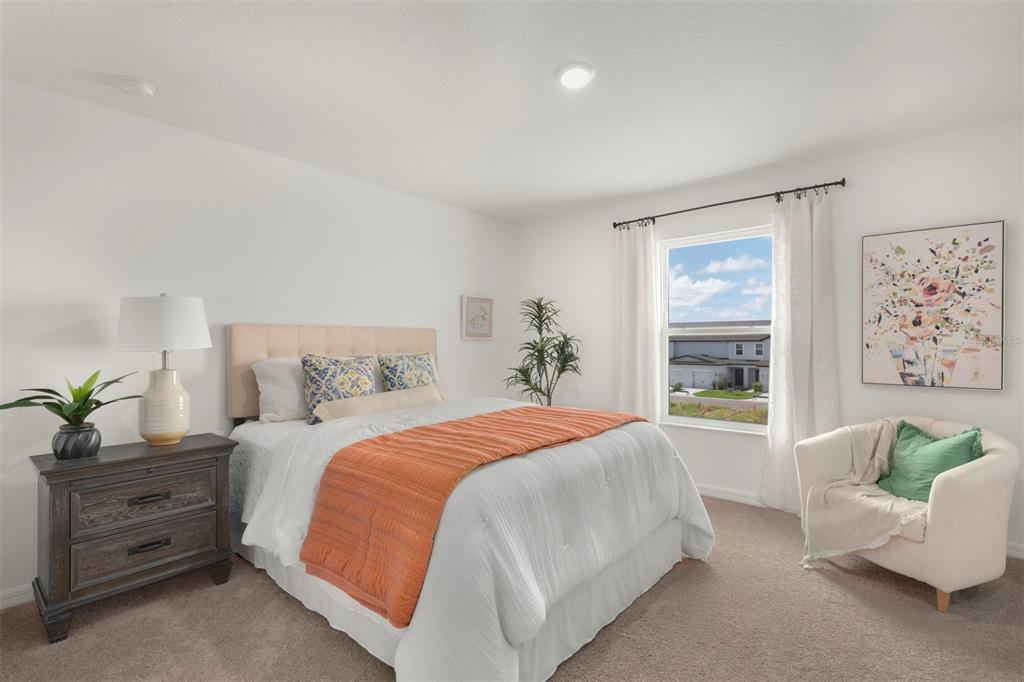 727 Poppy Lane Dundee, FL 33838 - Photo 16 of 31 a bedroom with a bed and a couch