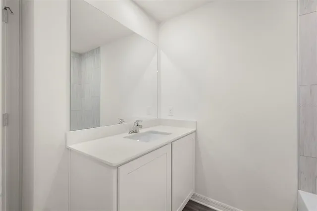 a white bath tub sitting next to a white toilet and a shower