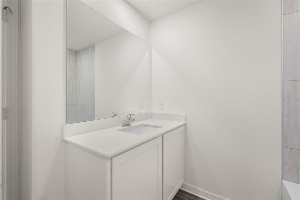 727 Poppy Lane Dundee, FL 33838 - Photo 21 of 31 a bathroom with a sink and a mirror