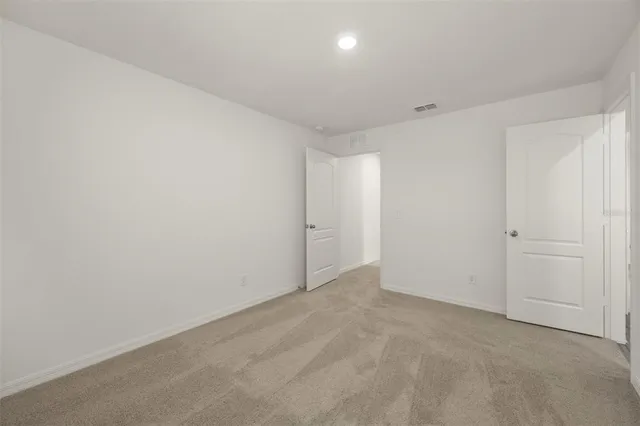 an empty room with a empty space and windows