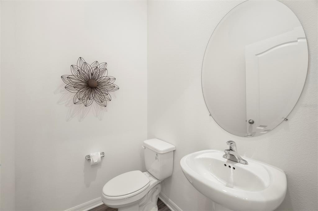 727 Poppy Lane Dundee, FL 33838 - Photo 25 of 31 a bathroom with a toilet sink and mirror