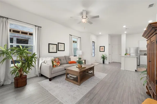 a living room with furniture and wooden floor