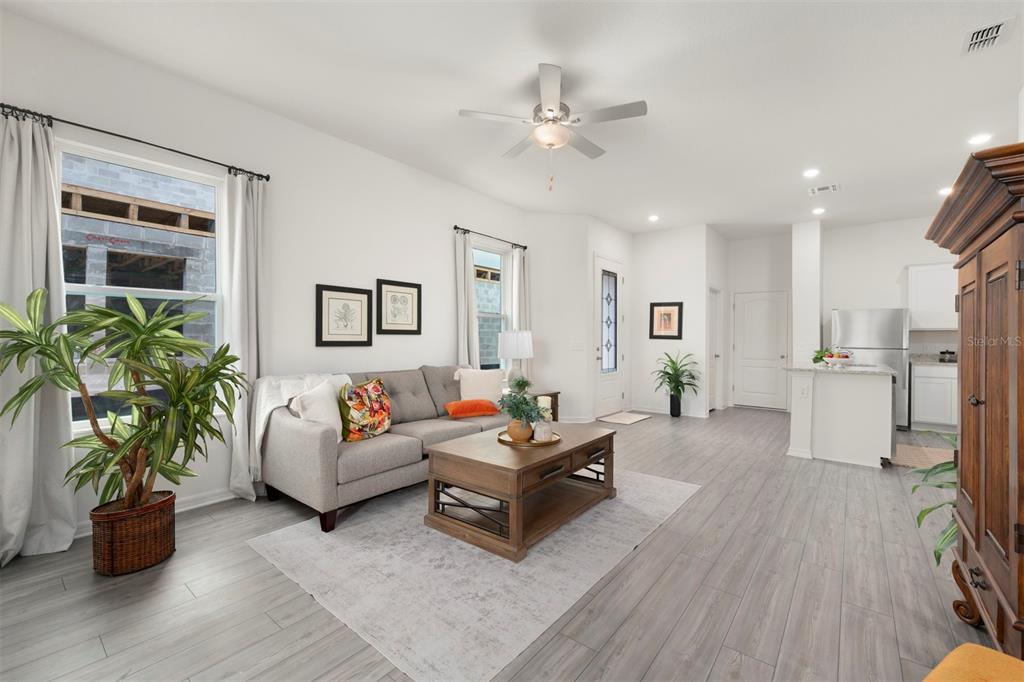 727 Poppy Lane Dundee, FL 33838 - Photo 8 of 31 a living room with furniture and wooden floor