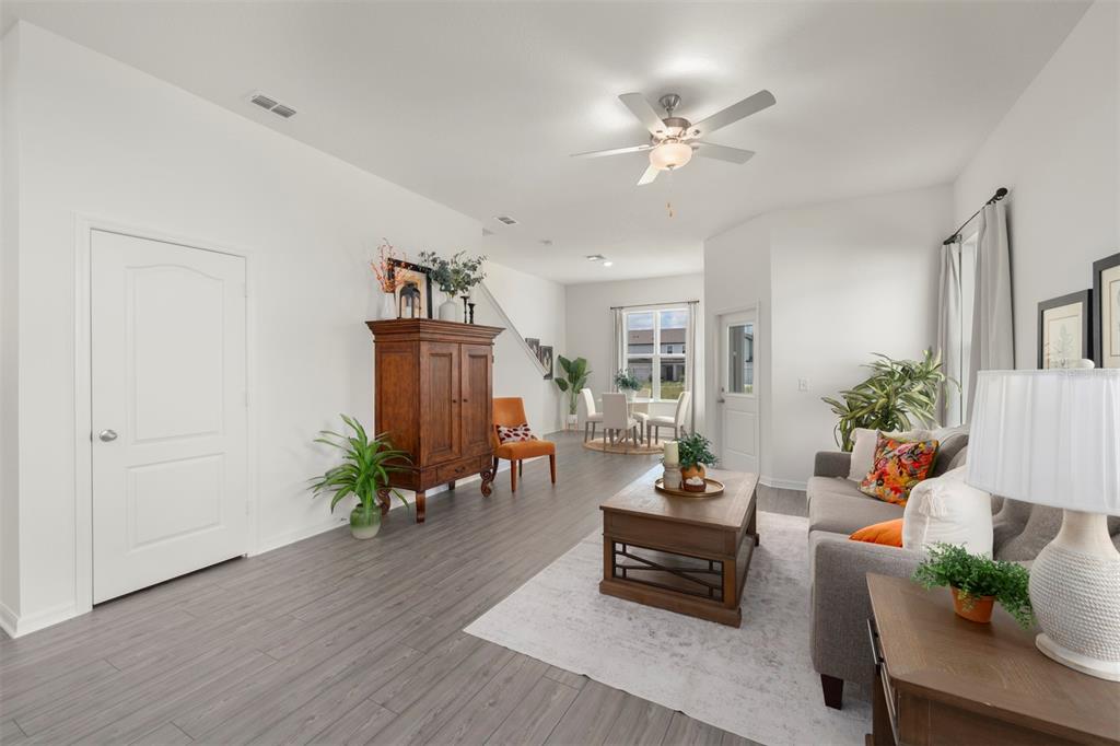 727 Poppy Lane Dundee, FL 33838 - Photo 10 of 31 a living room with furniture and a chandelier