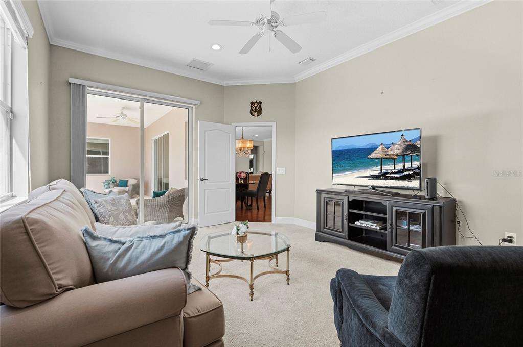 357 Marsh Creek Road Venice, FL 34292 - Photo 38 of 70 a living room with furniture a flat screen tv and a window