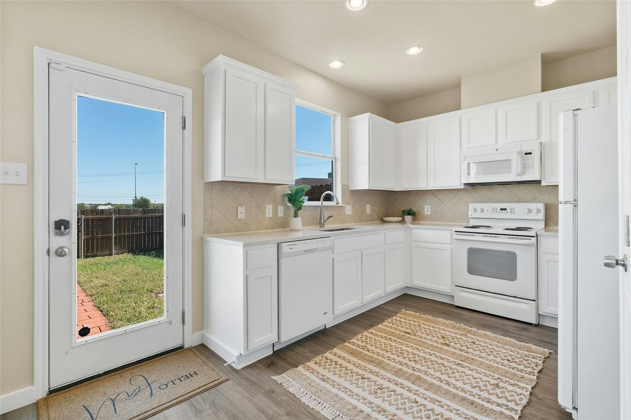 44 Verde Ranch Loop Leander, TX 78641 - Photo 7 of 24 a kitchen with stainless steel appliances granite countertop a stove a sink and a microwave