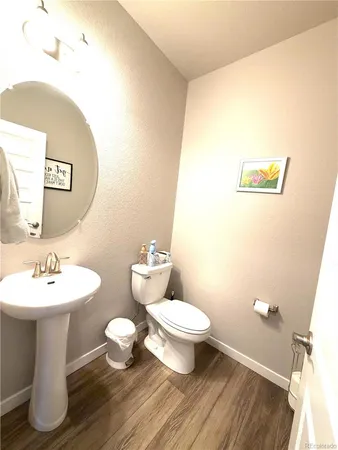 a bathroom with a sink mirror and toilet
