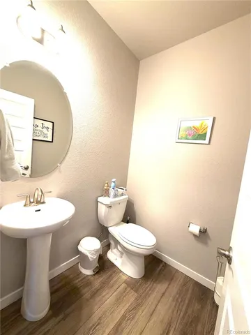 a bathroom with a sink mirror and toilet