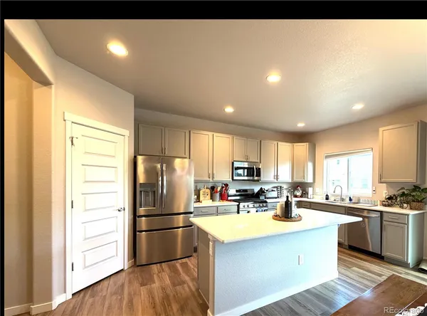 a kitchen with stainless steel appliances a refrigerator sink and cabinets