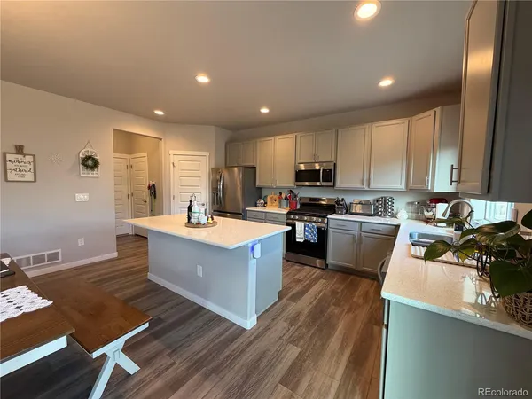 a view of kitchen with sink microwave and refrigerator