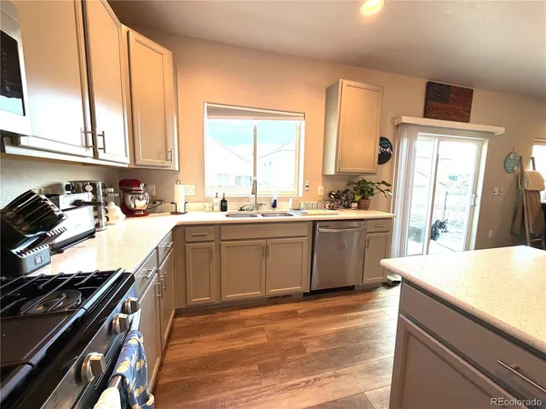 a kitchen with a sink stove top oven and cabinets