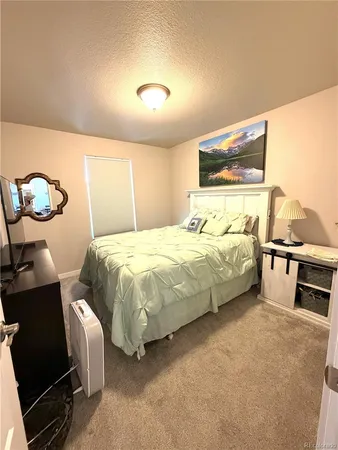 a bedroom with bed and window