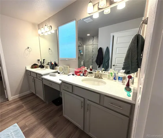 a bathroom with double vanity and a mirror