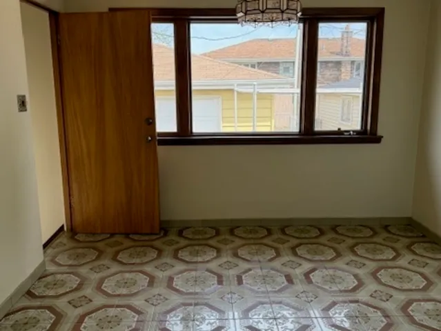 a room with a large window and furniture