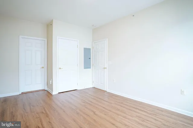 a view of an empty room with wooden floor