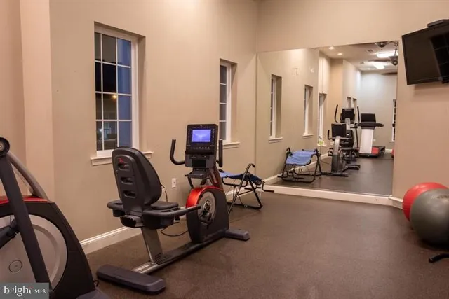 a view of a workspace with furniture and gym equipment