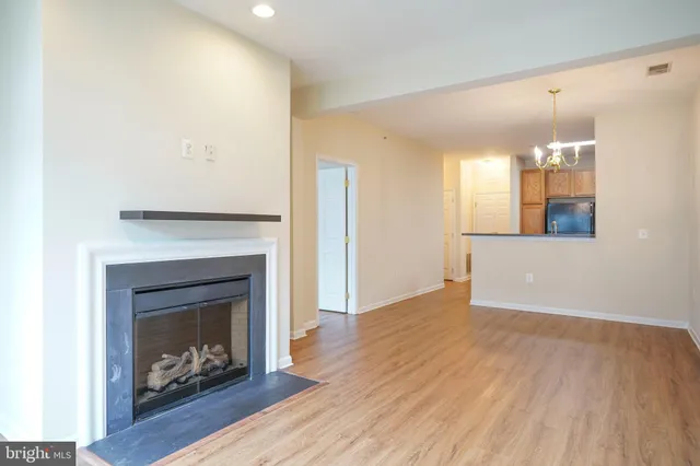 a view of a kitchen a fireplace and wooden floor