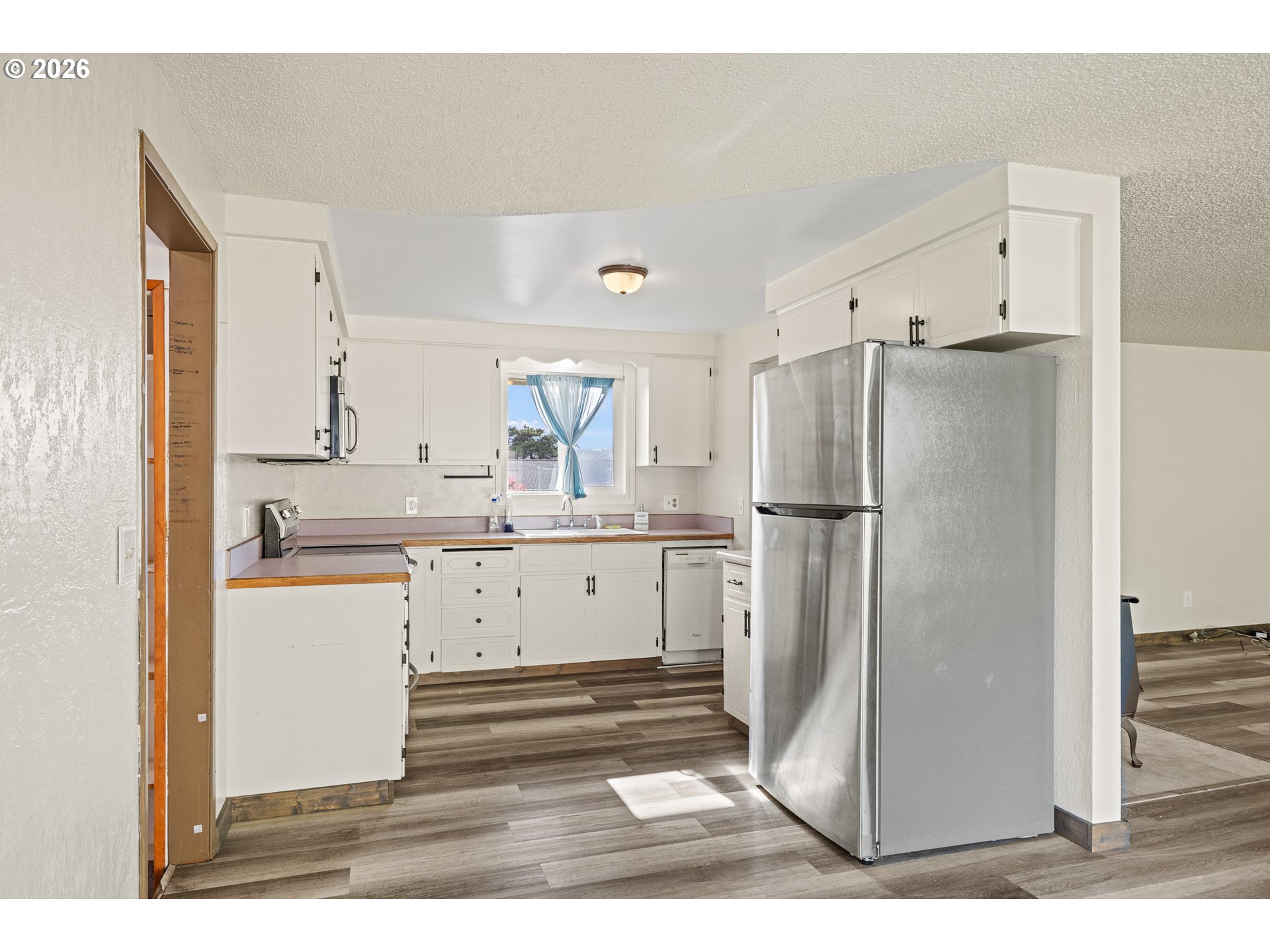 1816 Sunset Court Myrtle Point, OR 97458 - Photo 12 of 42 a kitchen with a refrigerator and a cabinets