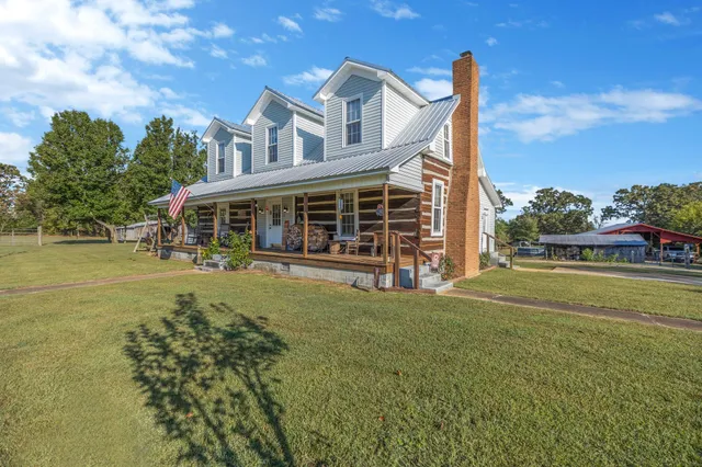 a view of house with outdoor space and swimming pool
