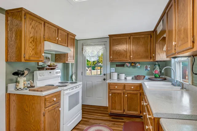 a kitchen with stainless steel appliances granite countertop sink stove and cabinets