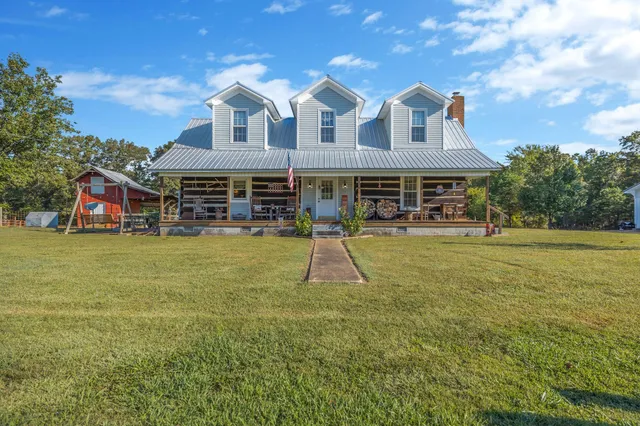 a view of a house with a yard patio and swimming pool