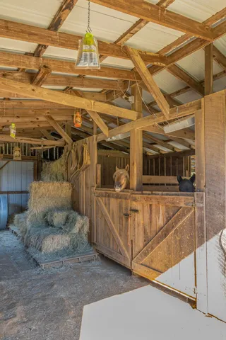 an aerial view of residential houses with outdoor space and trees all around