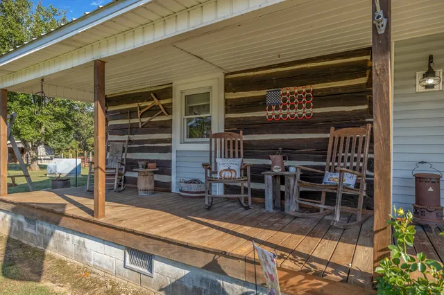 a view of a wine room with wooden floor and seating space