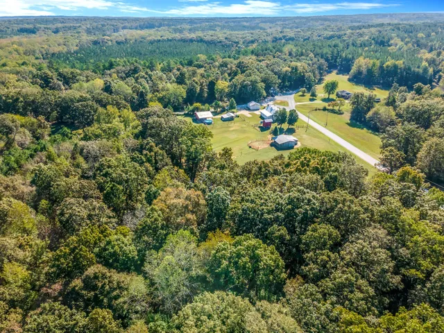 a view of a swimming pool with a yard and mountain view in back